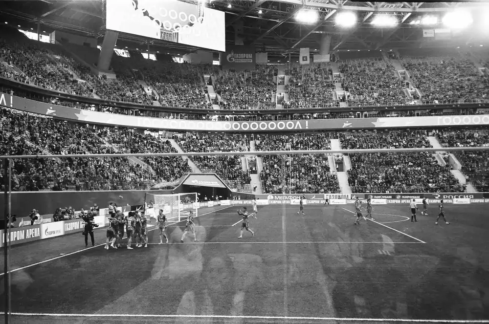A group of players celebrating and reviewing scores after a match